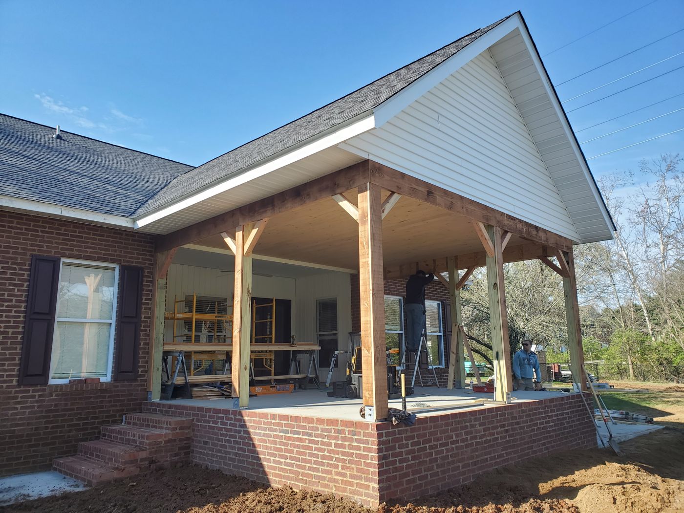 Covered porch addition on a brick home